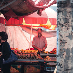 People working at market stall