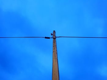 Low angle view of pole against clear blue sky