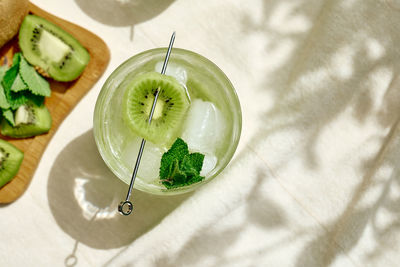 Summer cold drink and beverages. lemonade with kiwi, mint and ice in drinking glass. 