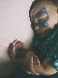 Midsection of woman relaxing on bed