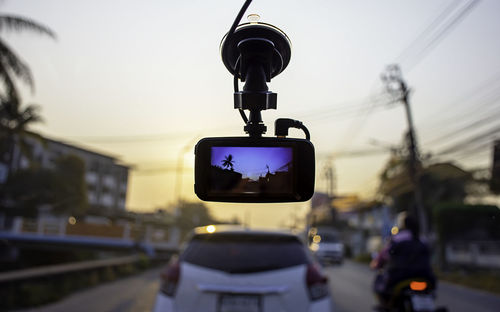 Traffic light on road against sky in city