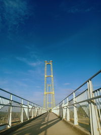 Low angle view of bridge against blue sky