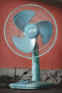 Close-up of electric fan against wall