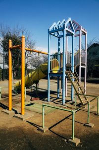 Playground in park against clear sky