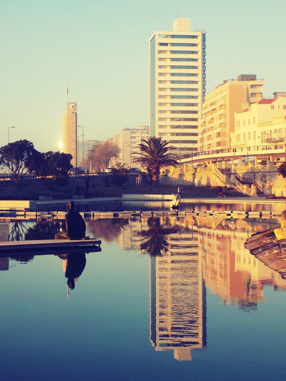 architecture, building exterior, built structure, clear sky, water, reflection, city, waterfront, river, copy space, sunset, lake, skyscraper, standing water, tower, city life, cityscape, building, silhouette