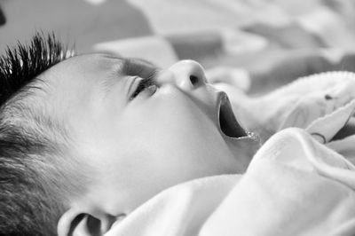 Close-up portrait of cute baby lying down