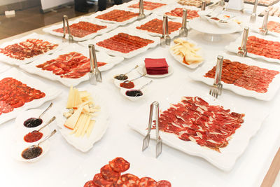 High angle view of meat in plates on table