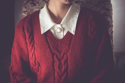 Midsection of woman wearing sweater