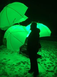 Rear view of a man with umbrella