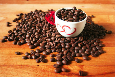 Coffee beans and lovely cup with two hearts