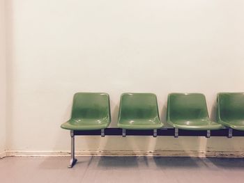 Chairs and table against wall