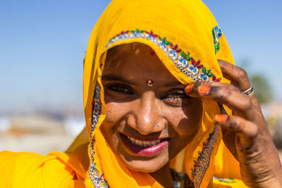 Close-up portrait of smiling young woman 