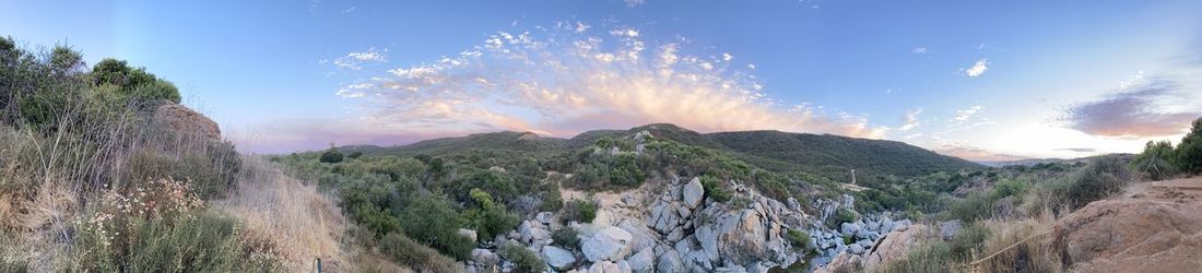 Panoramic view of land and mountains against sky