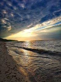 Scenic view of beach against sky during sunset