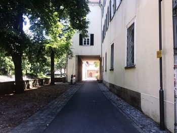 Empty alley amidst buildings in city