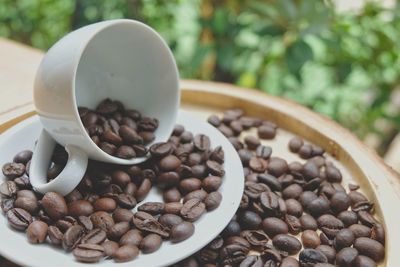 High angle view of coffee beans in bowl on table