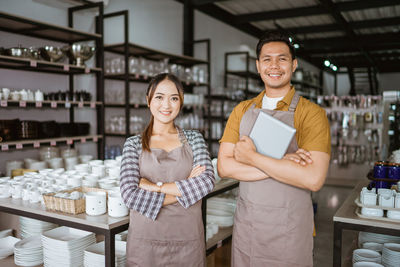 Portrait of smiling friends standing in store