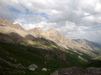 Scenic view of mountains against cloudy sky