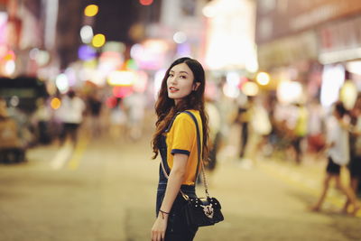 Woman standing on street in city