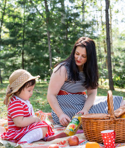 Happy girl sitting on wicker basket