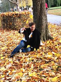 Portrait of smiling boy in park during autumn