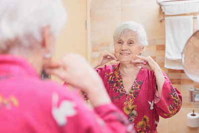 Mature woman taking care of her face