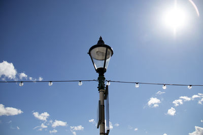 Low angle view of street light against sky