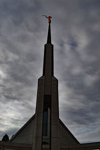 Low angle view of building against cloudy sky