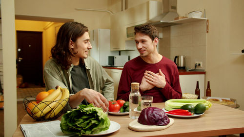 Young man having food at home