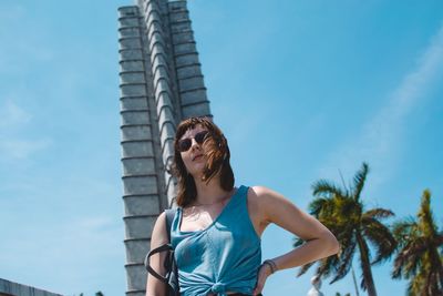 Low angle view of woman standing against sky