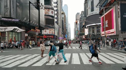 People walking on road in city