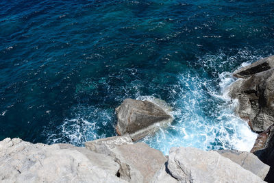 High angle view of rocks by sea