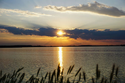 Scenic view of lake against sky during sunset