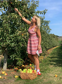 Full length of woman standing on tree