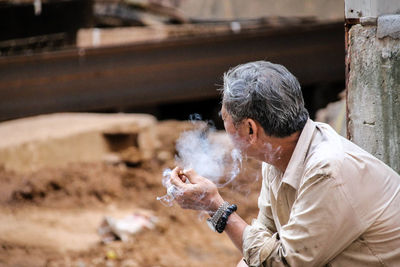 Full length of man holding cigarette