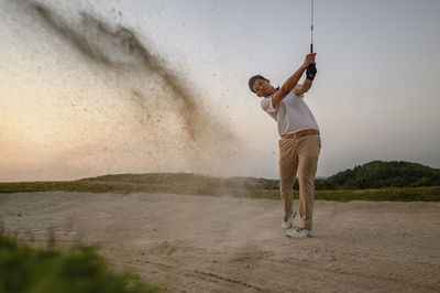 Full length of man playing golf