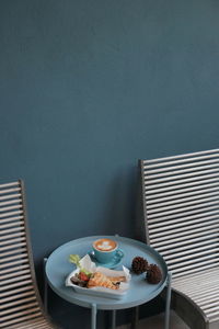 High angle view of breakfast served on table by wall