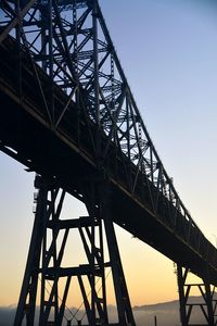 Low angle view of silhouette bridge against sky during sunset