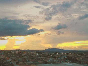 Aerial view of townscape against sky at sunset