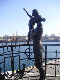 Statue of man at harbor