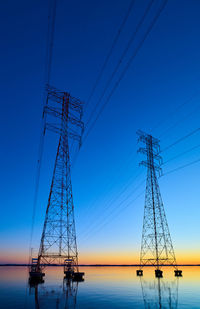 High voltage transmission lines crossing wheeler lake at dusk near athens al. 