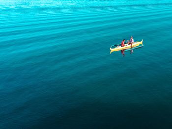 People sitting on boat in sea