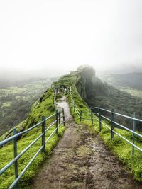 Scenic view of landscape against sky during foggy weather