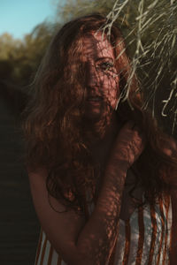 Portrait of young woman standing outdoors