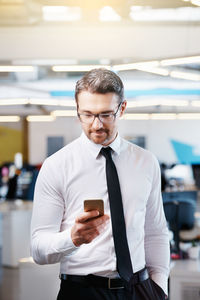 Businessman using mobile phone at office