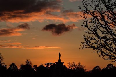 Silhouette trees against romantic sky at sunset