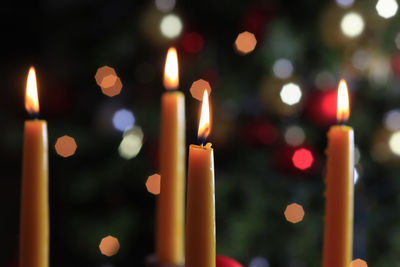 Close-up of lit candles in temple