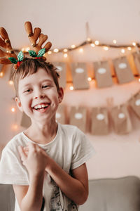 Happy boy greets christmas. christmas mood at home. boy rejoices at christmas. christmas morning. 