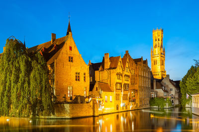 Reflection of illuminated buildings in lake