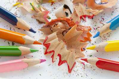 High angle view of multi colored pencils and shavings on table